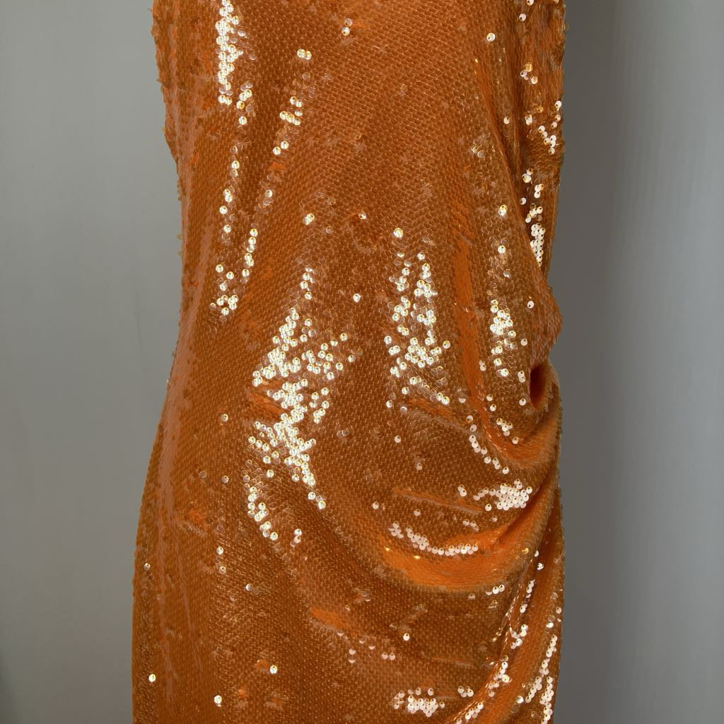 Close-up of a brown sequined fabric against a gray background
