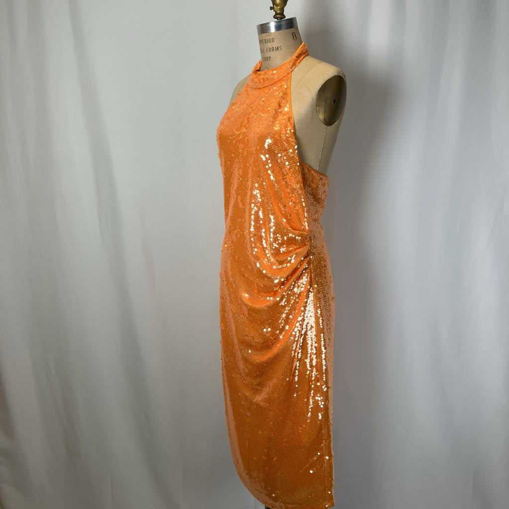Orange sequin dress on a mannequin against a plain background