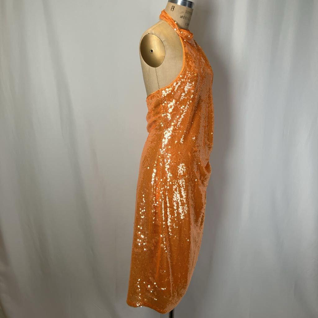 Orange sequin dress on a mannequin against a plain background