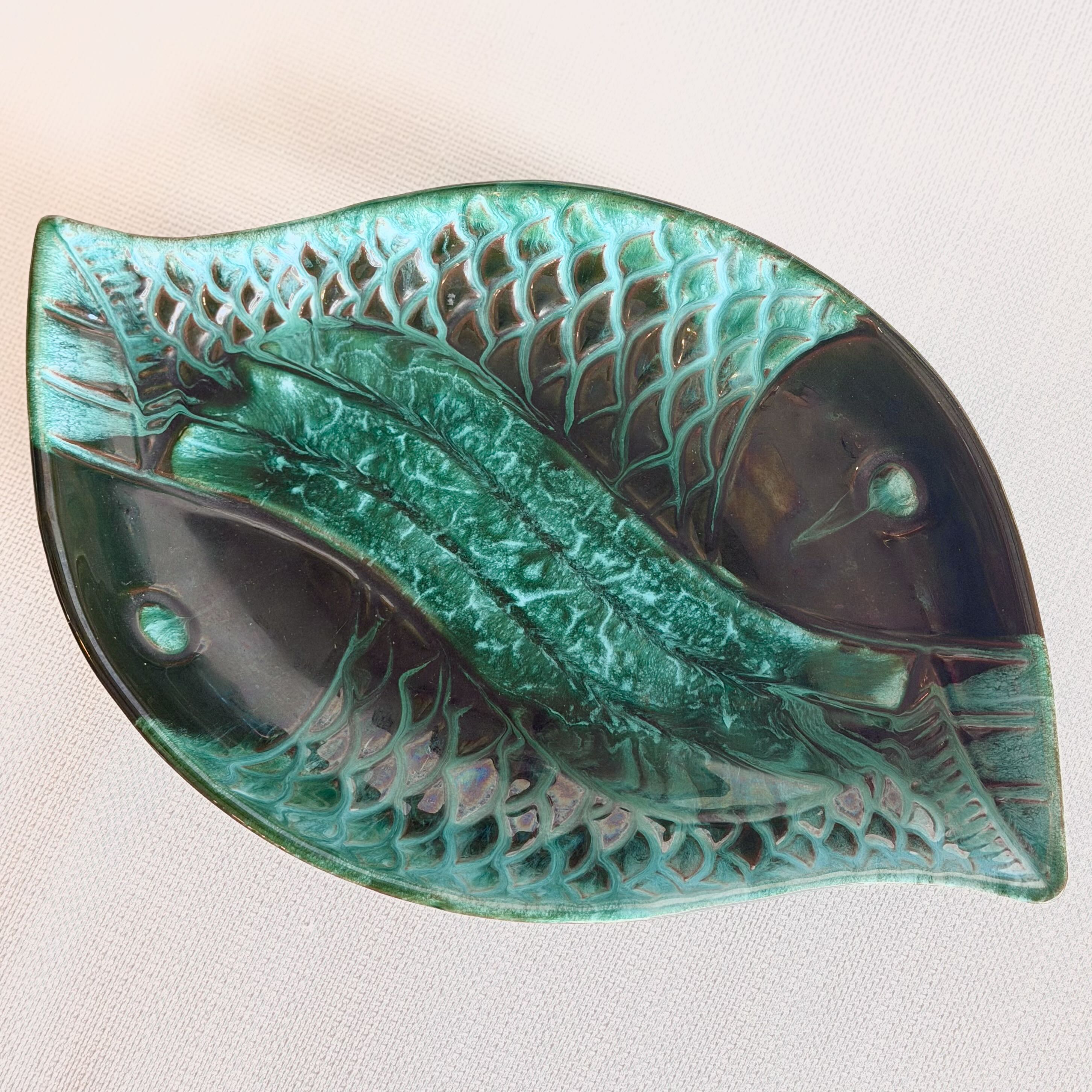 Decorative leaf-shaped object with intricate patterns on a light background