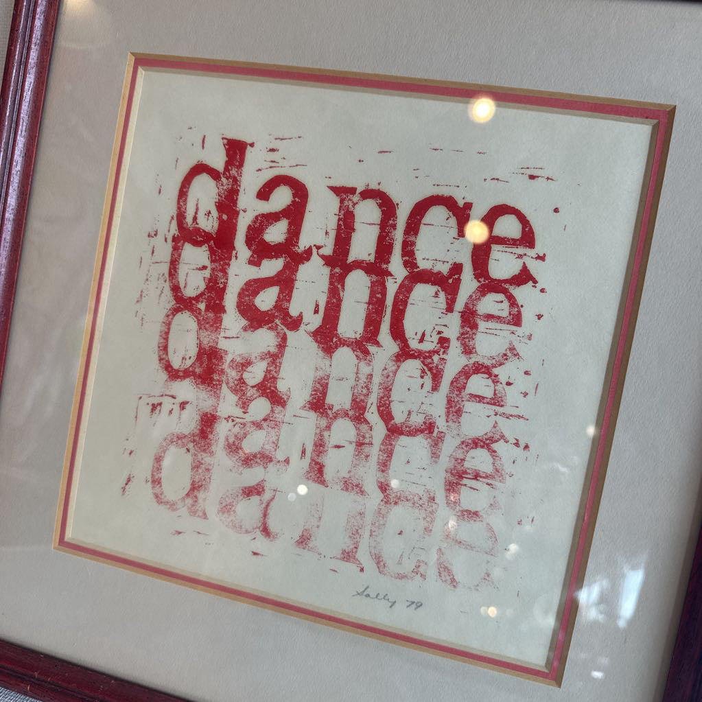 Framed artwork with red text on a white background