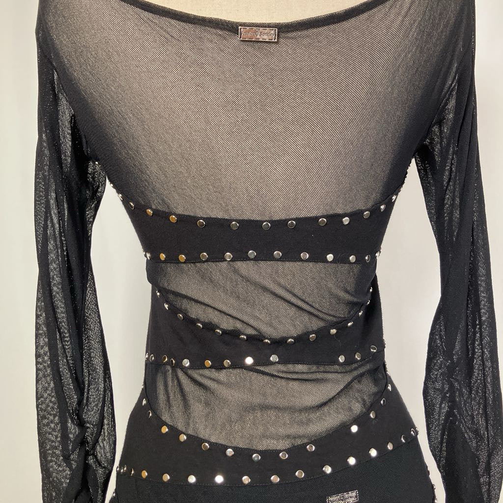 Black sheer top with studded details on a neutral background