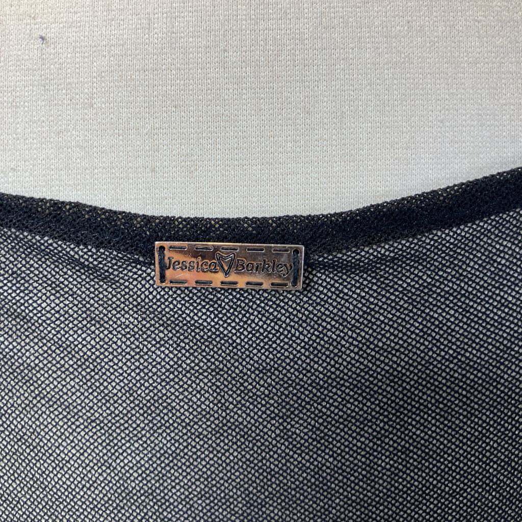 Close-up of a textured fabric surface with a brand label on a gray background
