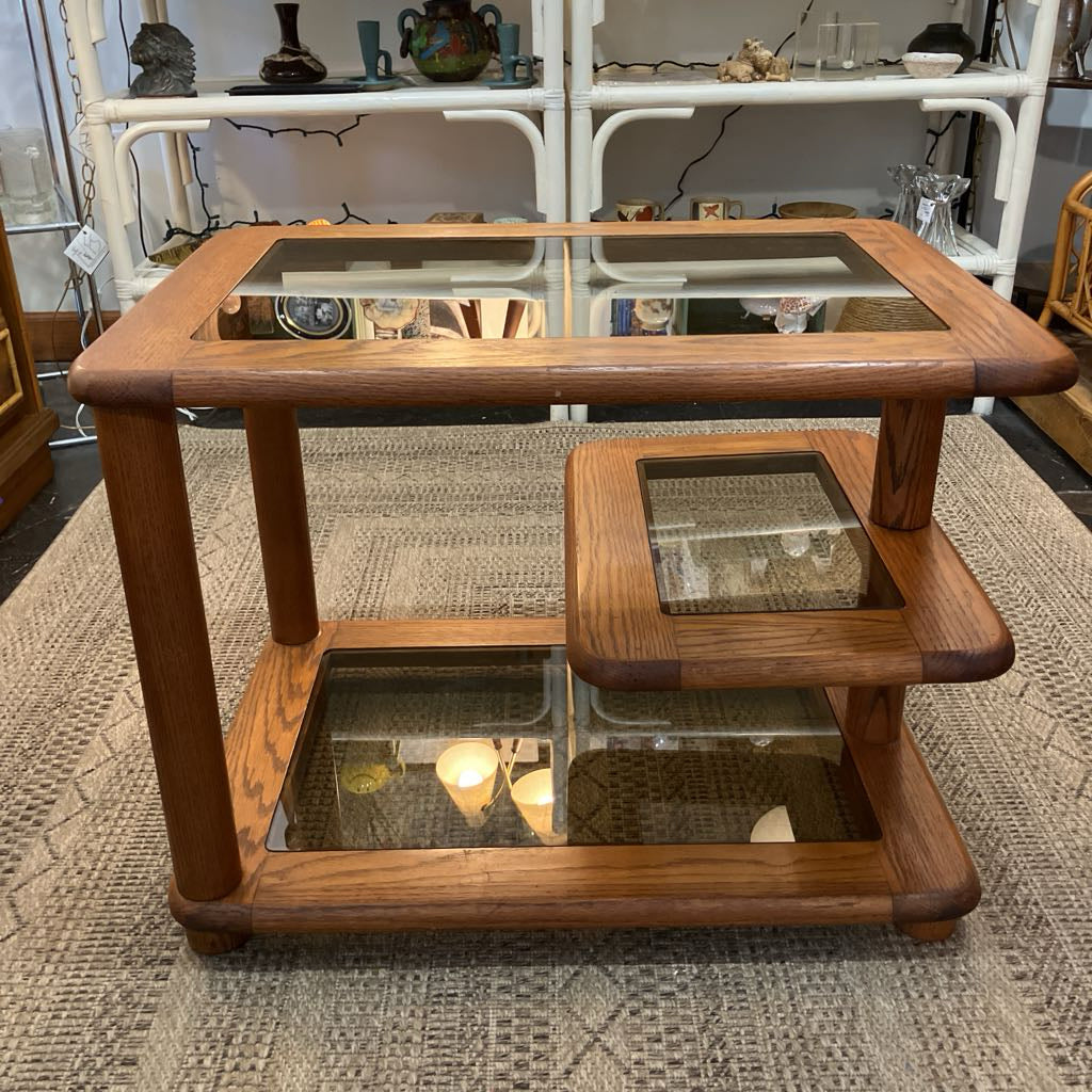 Wooden coffee table with glass top on a textured rug