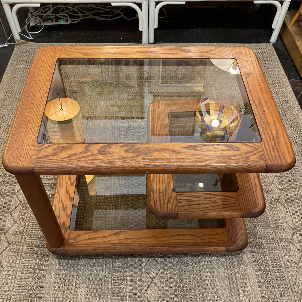 Wooden coffee table with glass top on a textured rug