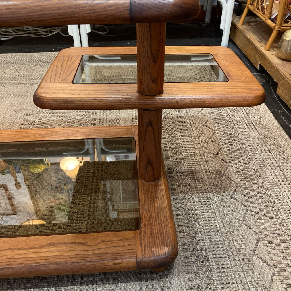 Wooden coffee table with glass top on a textured floor