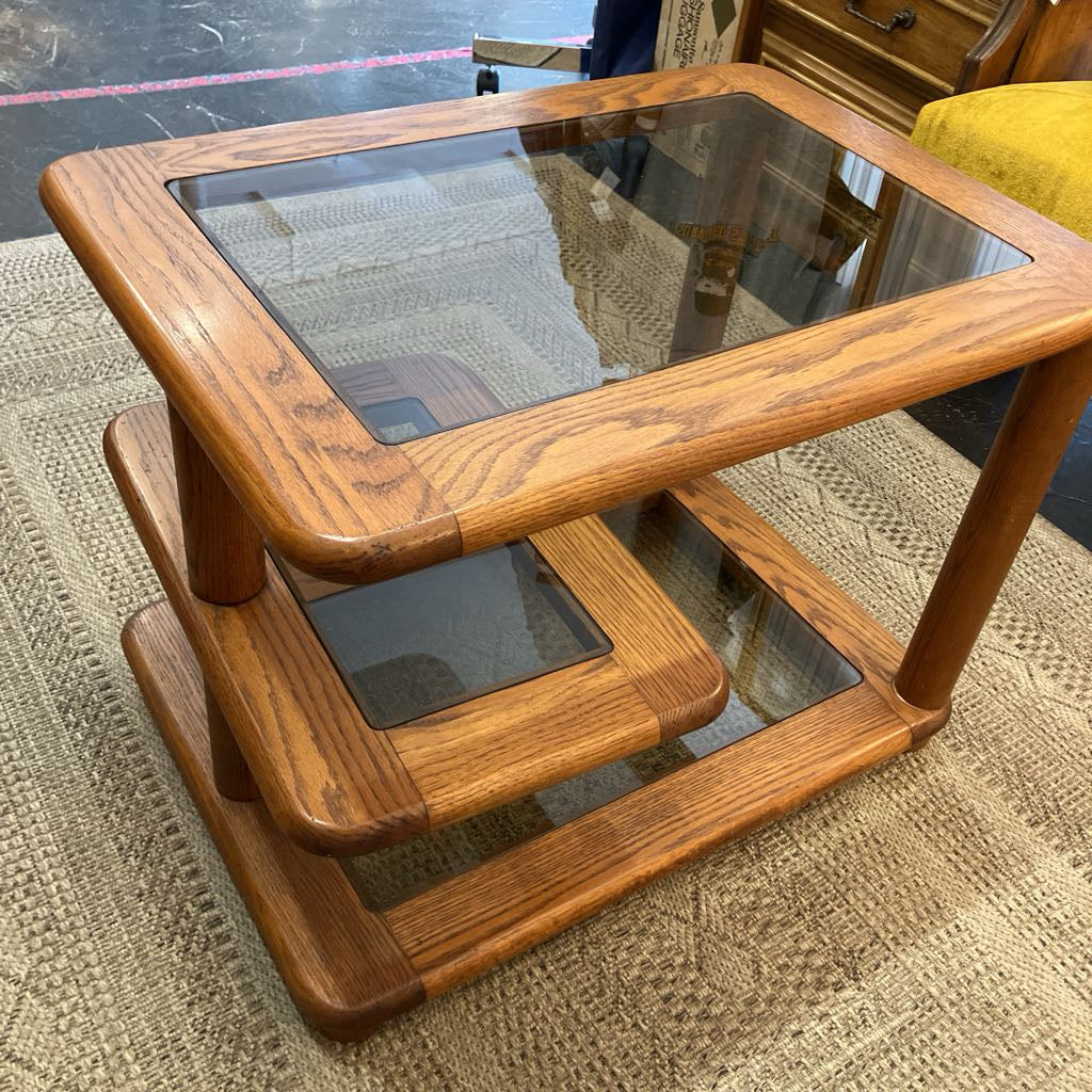 Wooden table with glass top on a carpeted floor