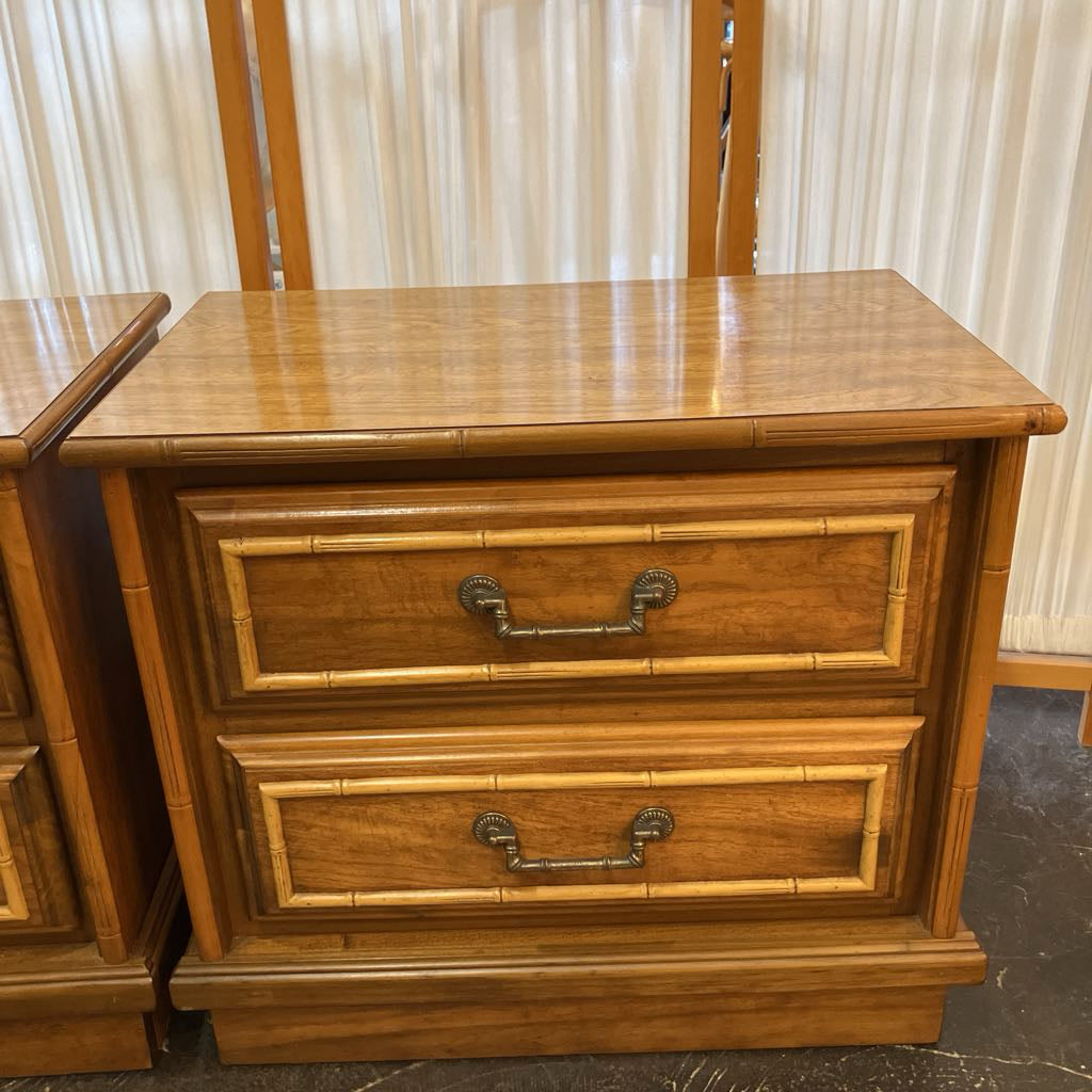 Wooden nightstand with two drawers and bamboo-style design.