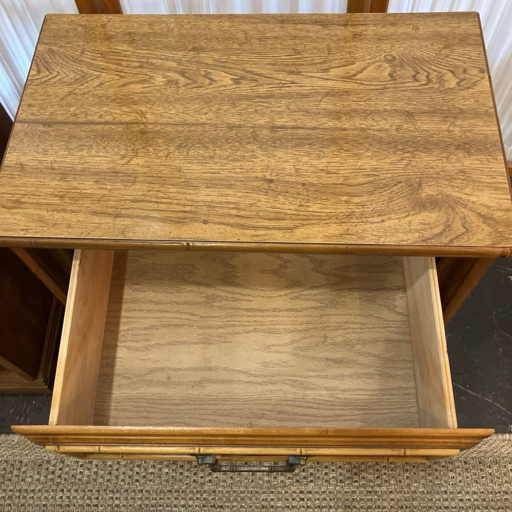 Wooden side table with an open drawer