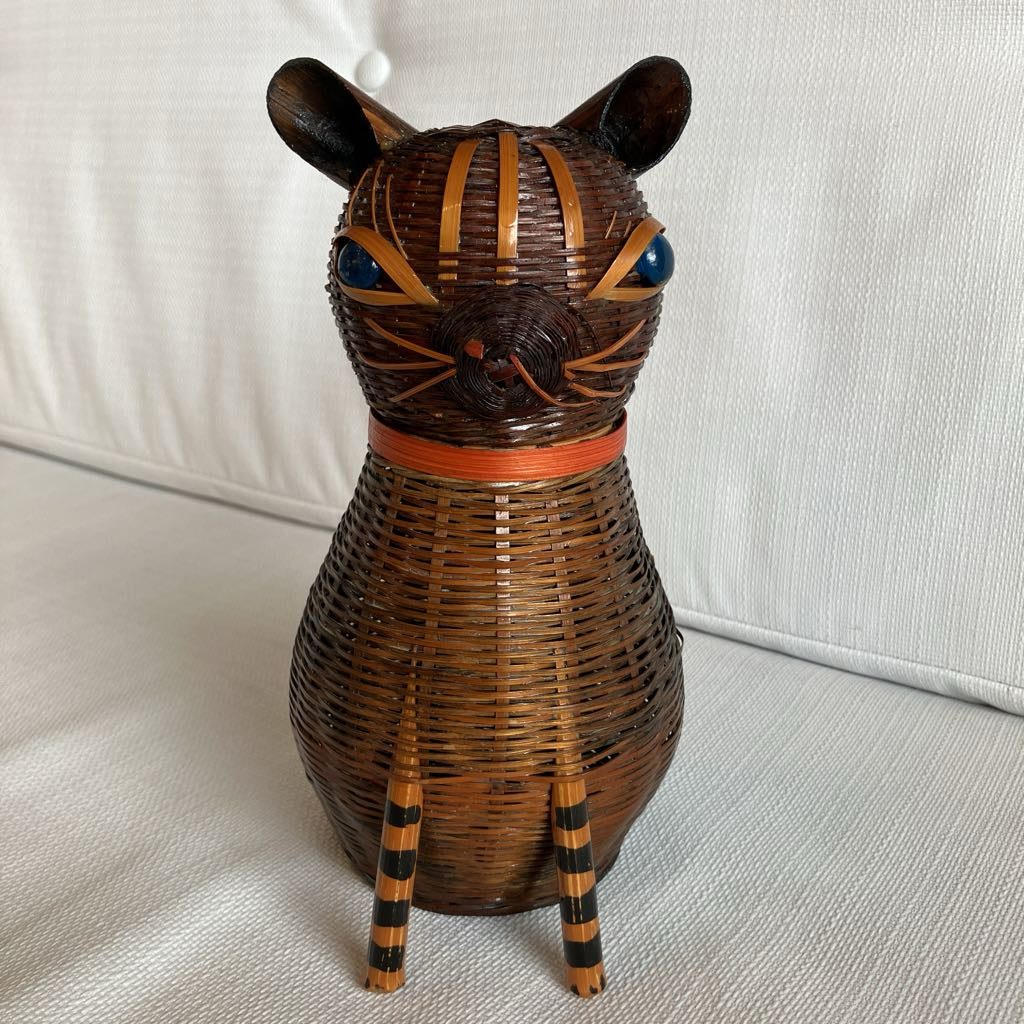 Wicker cat-shaped decorative item on a light-colored surface