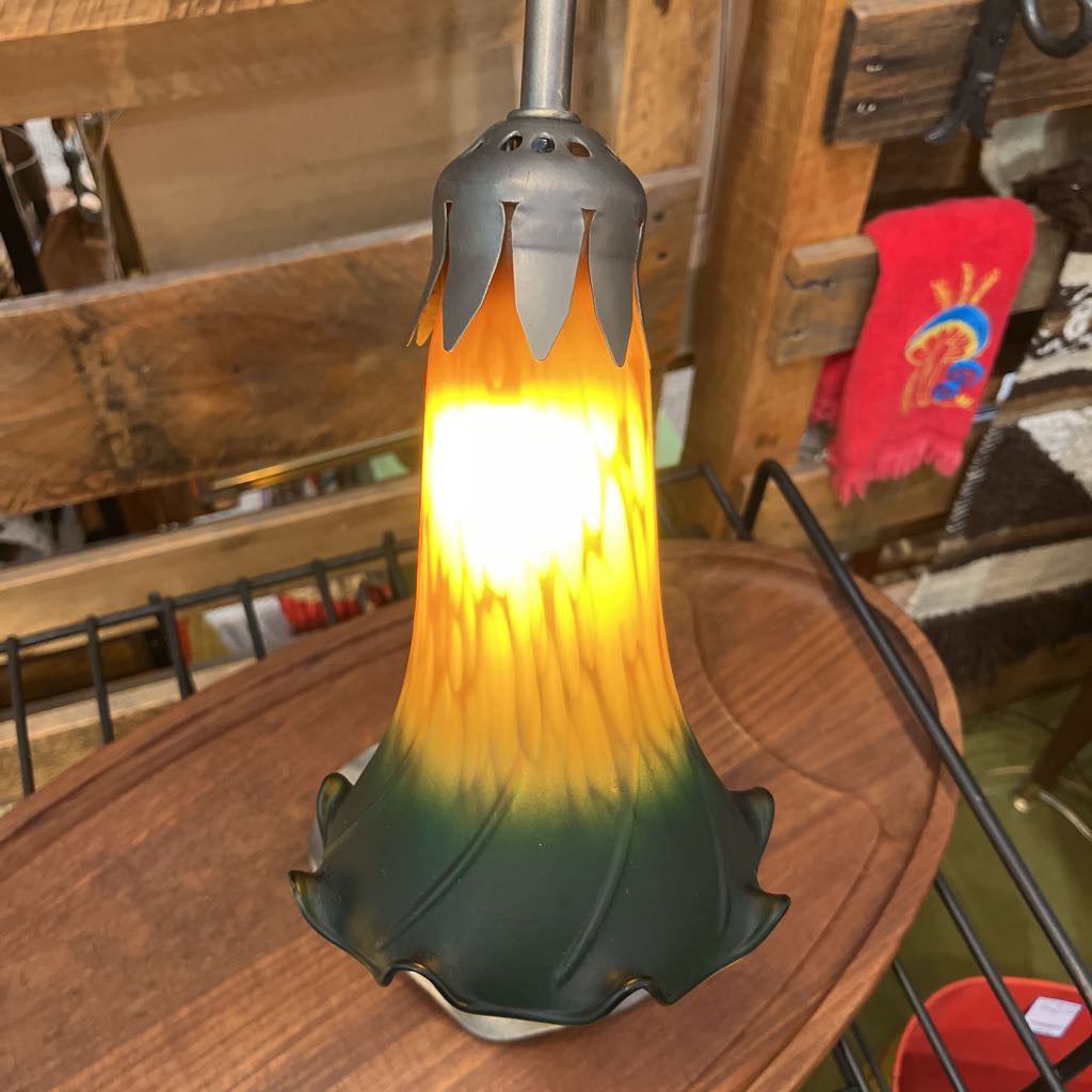 Glass lamp with a unique design on a wooden surface