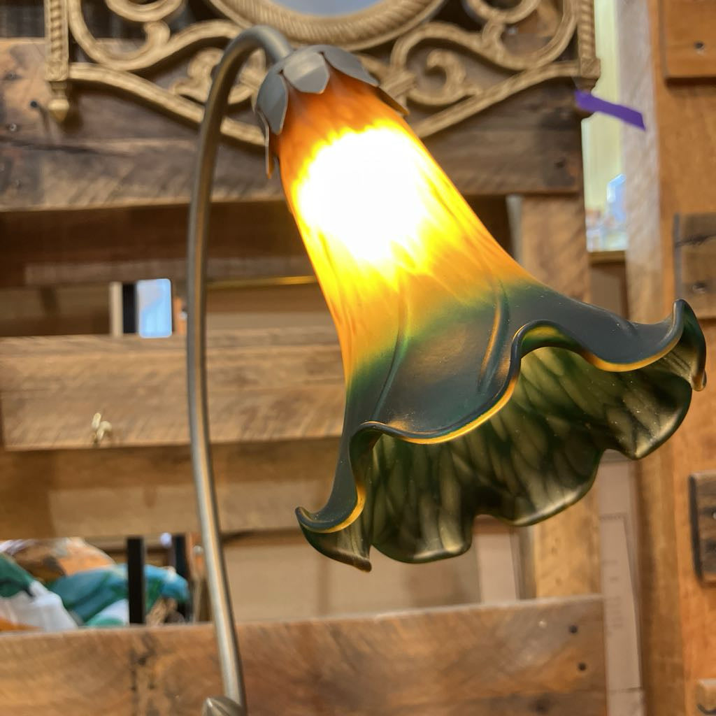 Decorative lamp with a colorful glass shade in a rustic setting