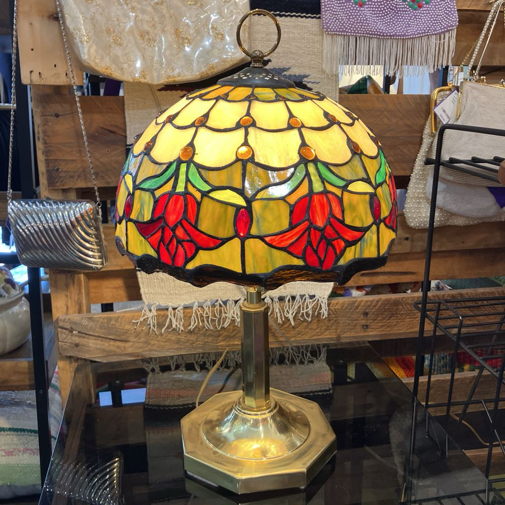 Stained glass lamp with floral design on a wooden surface
