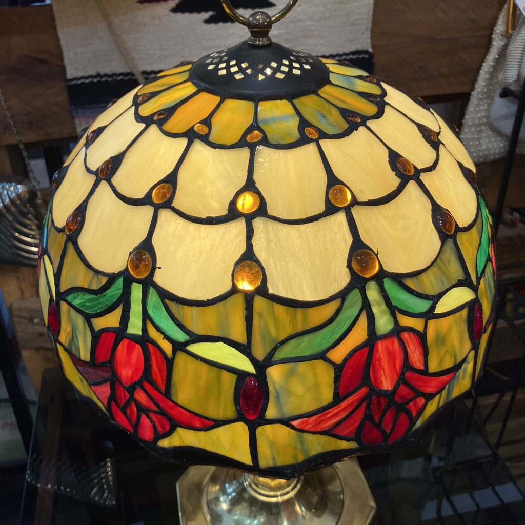Stained glass lamp with floral design on a blurred background