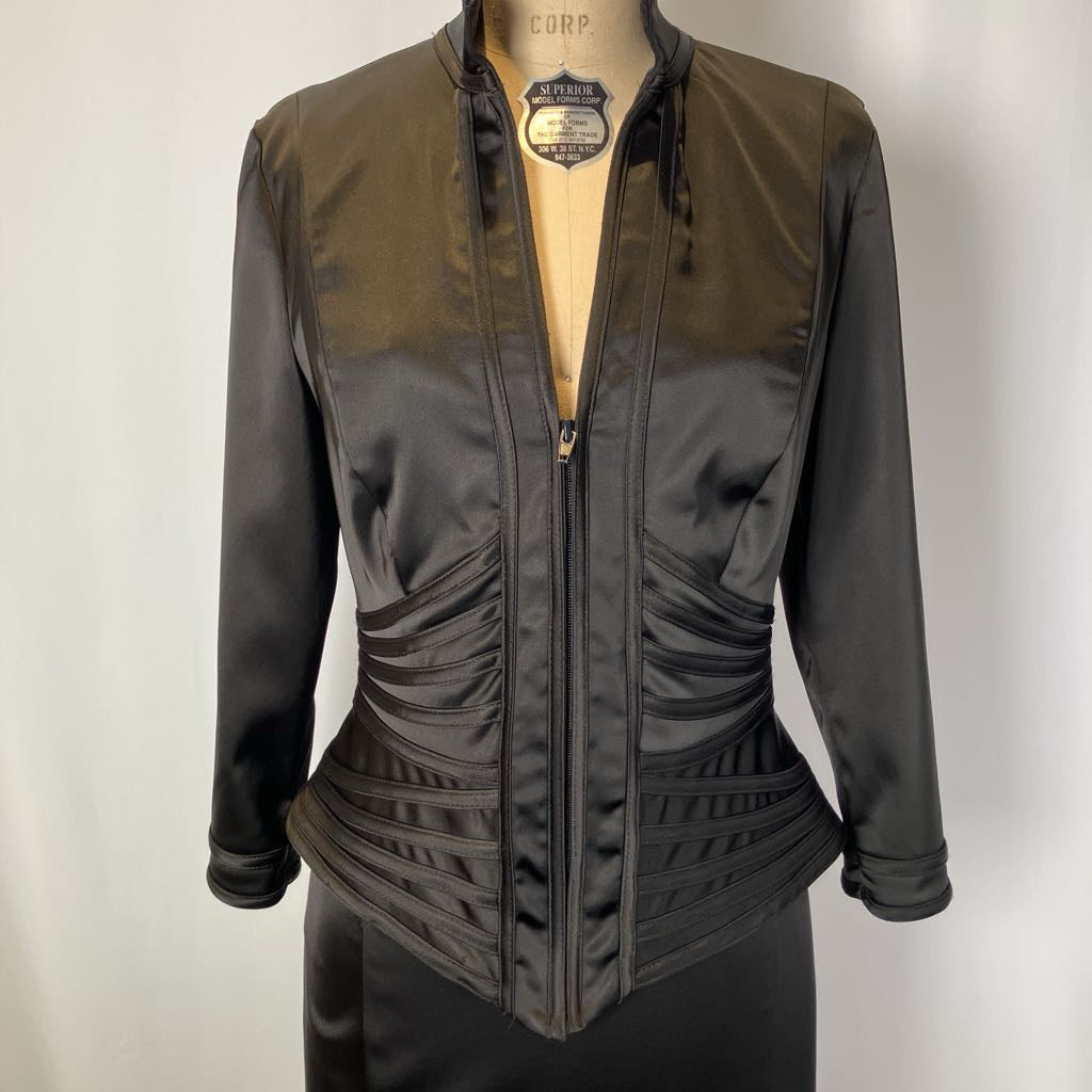 Black and brown jacket on a mannequin against a plain background