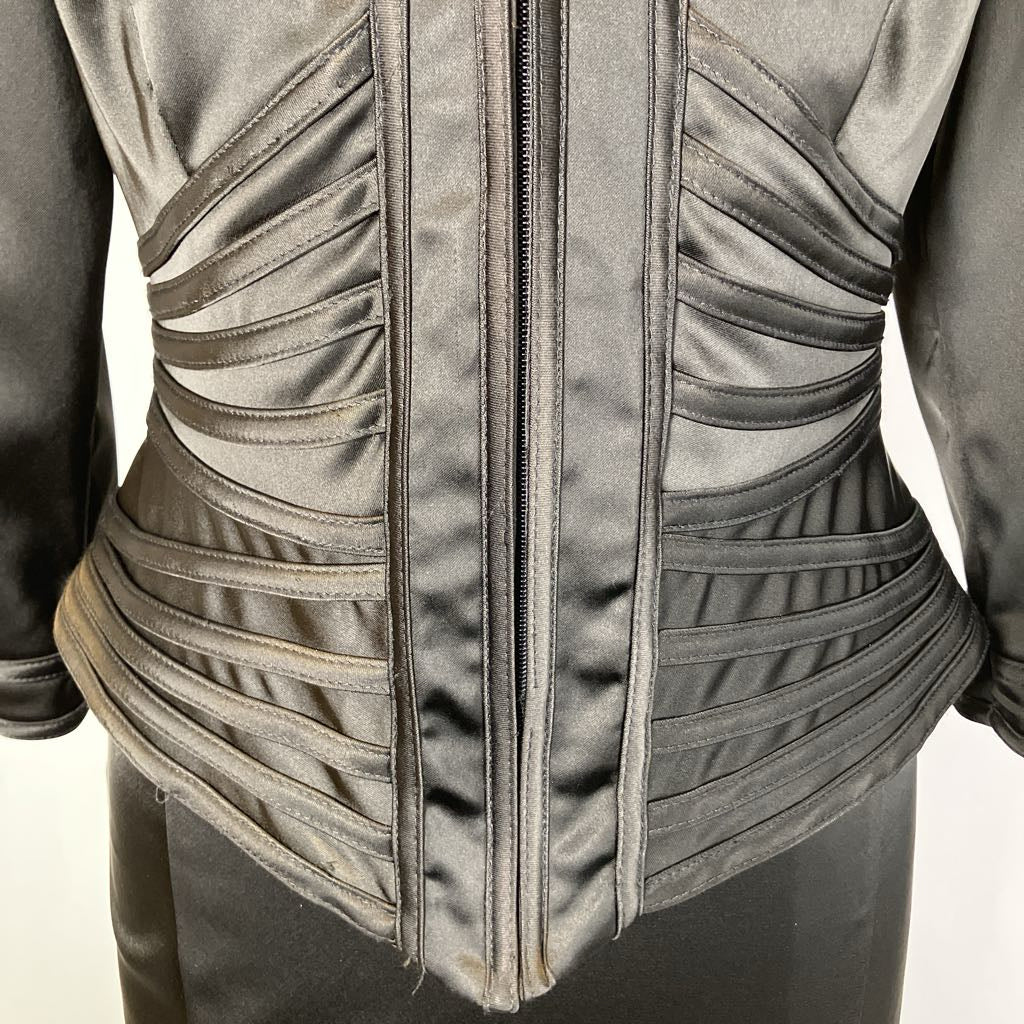 Close-up of a textured jacket with a zipper on a neutral background