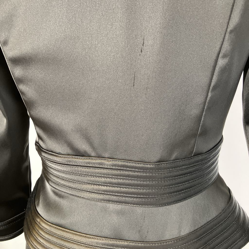 Close-up of a gray leather outfit with a belt