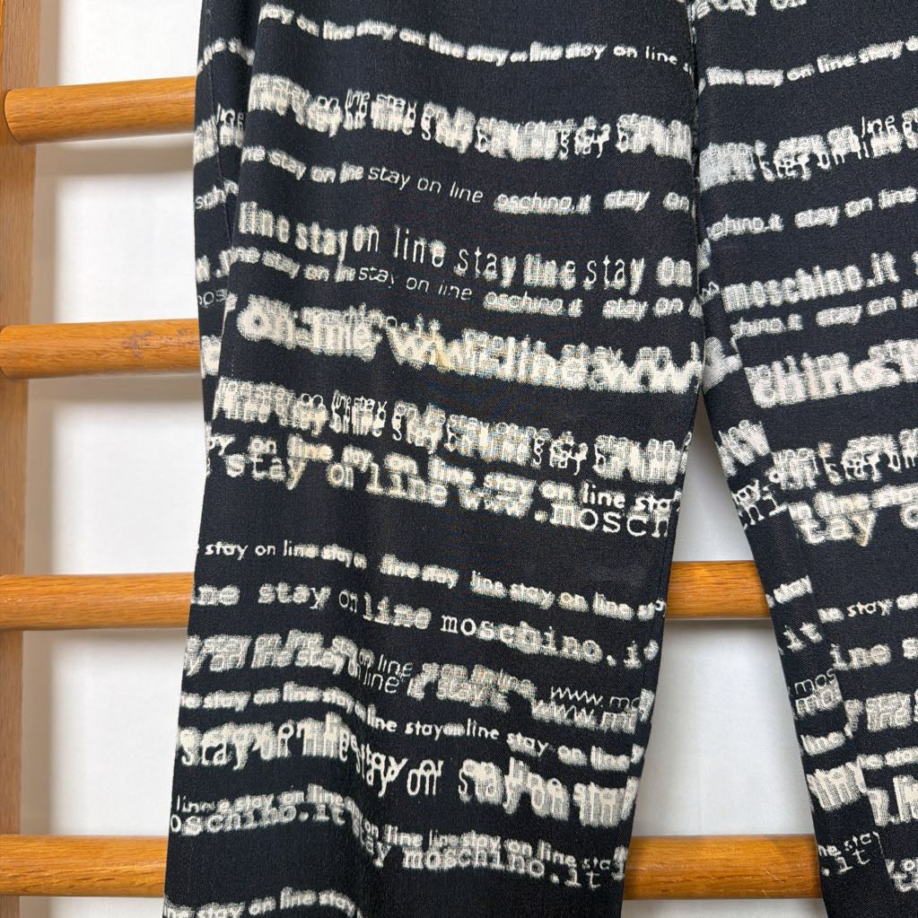 Black tie with white text pattern on a wooden rack