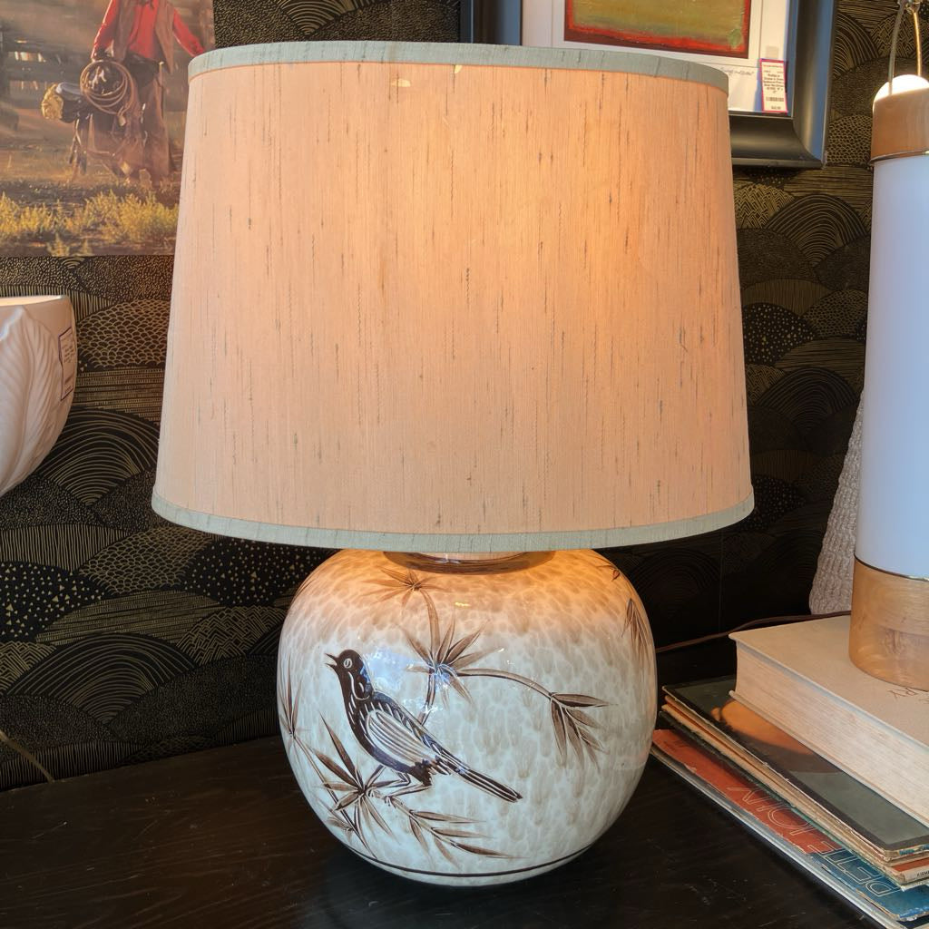 Decorative lamp with a bird design on a table