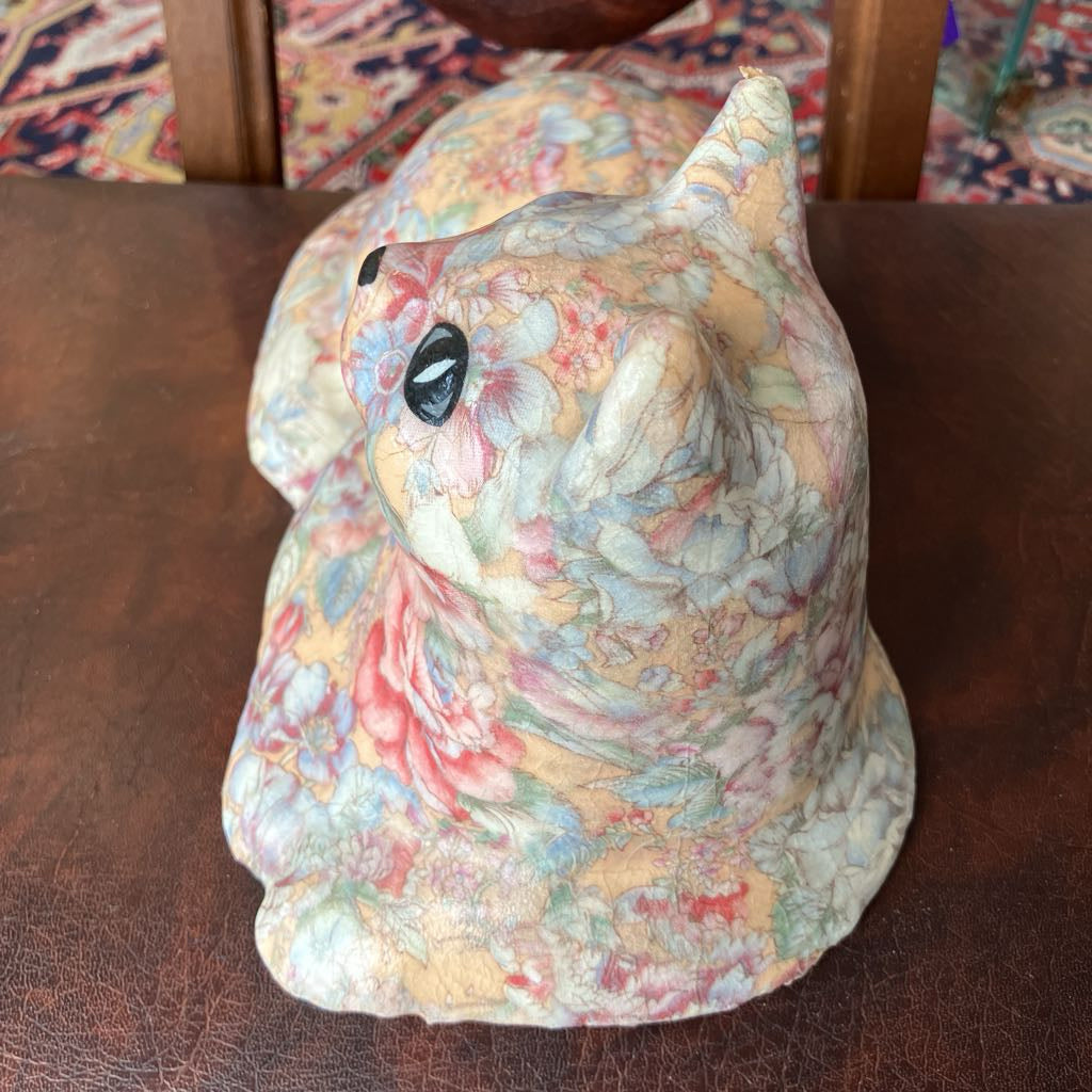 Decorative ceramic rabbit with floral patterns on a wooden surface