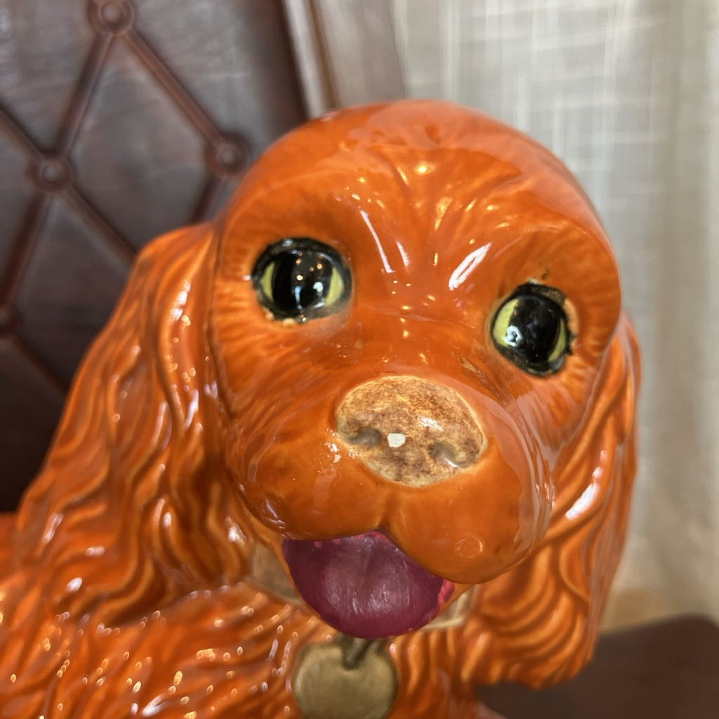 Ceramic dog figurine with a brown background