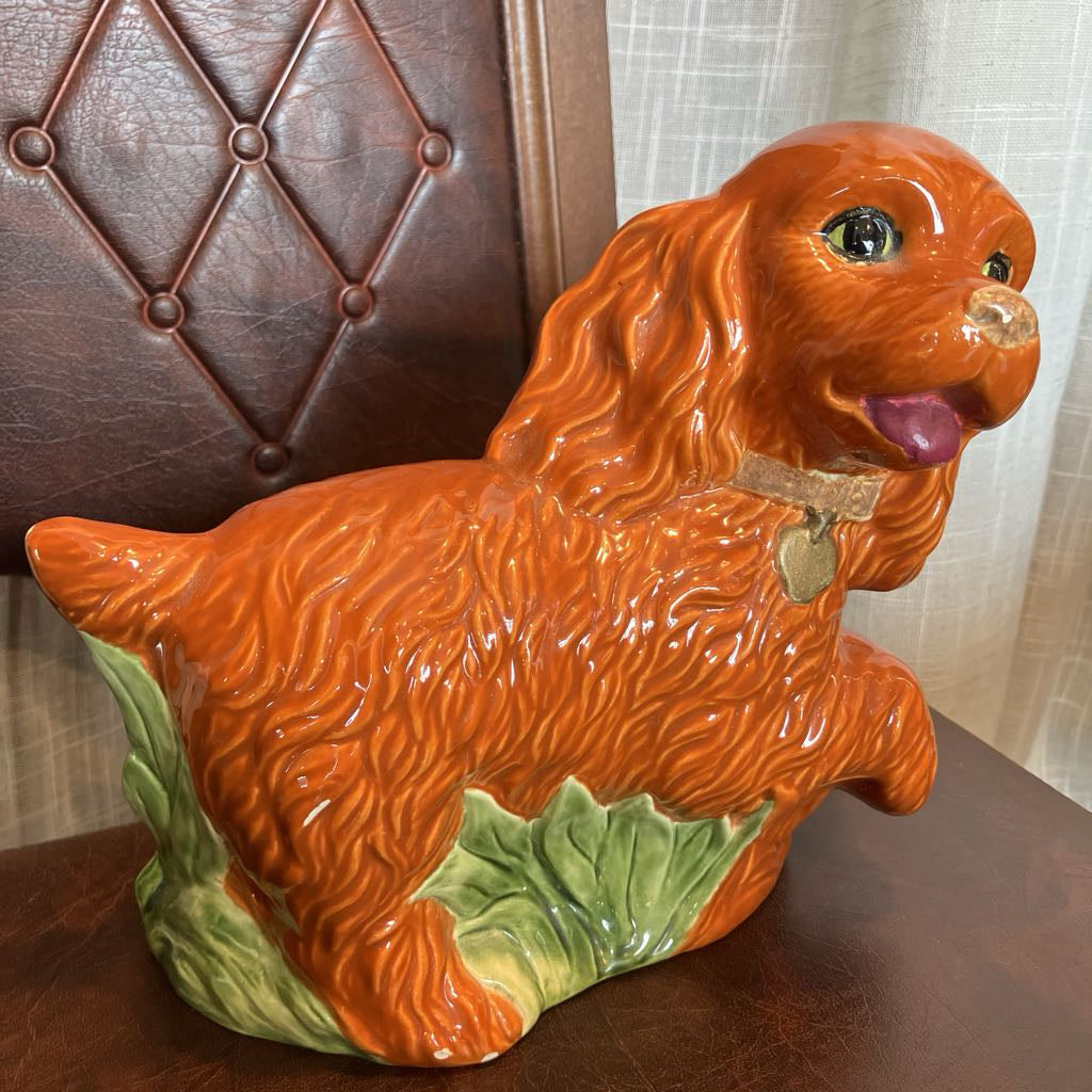 Ceramic dog figurine with a brown background