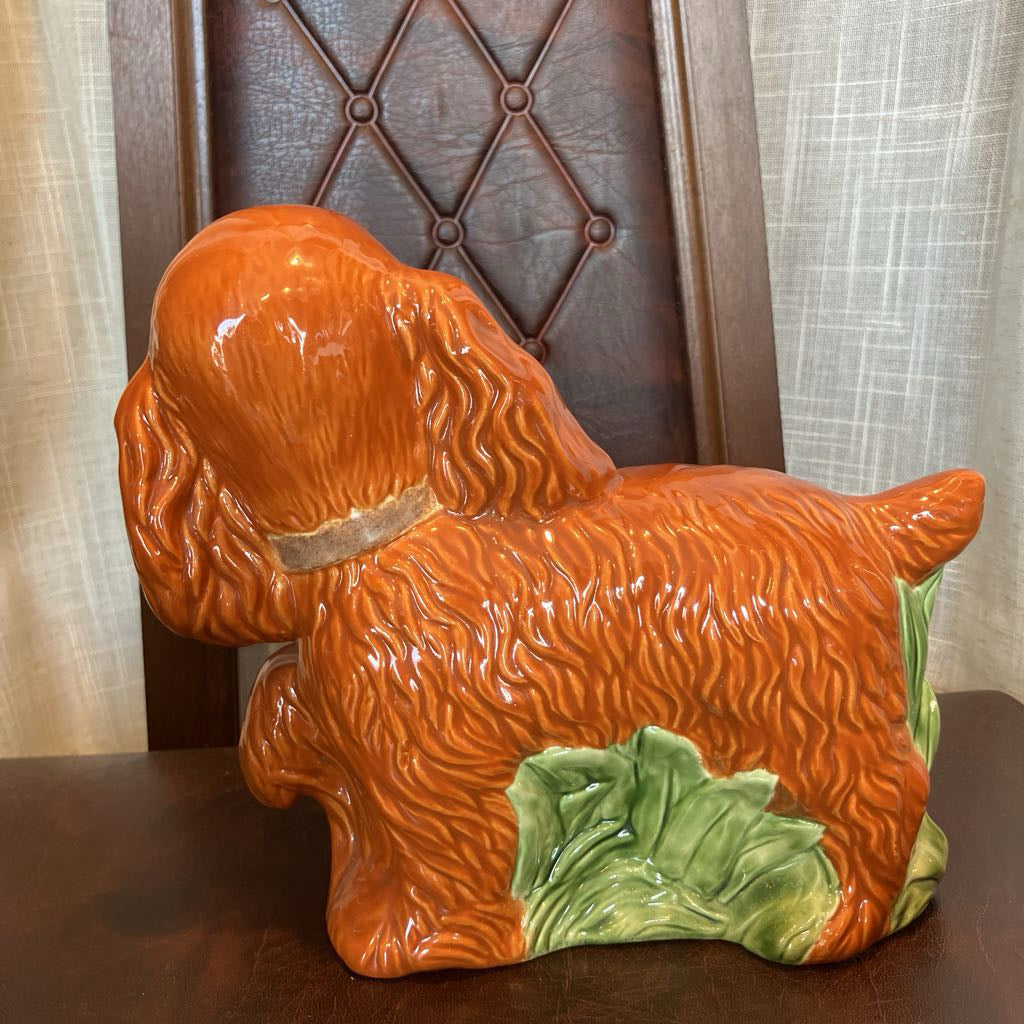 Ceramic dog figurine with a brown background
