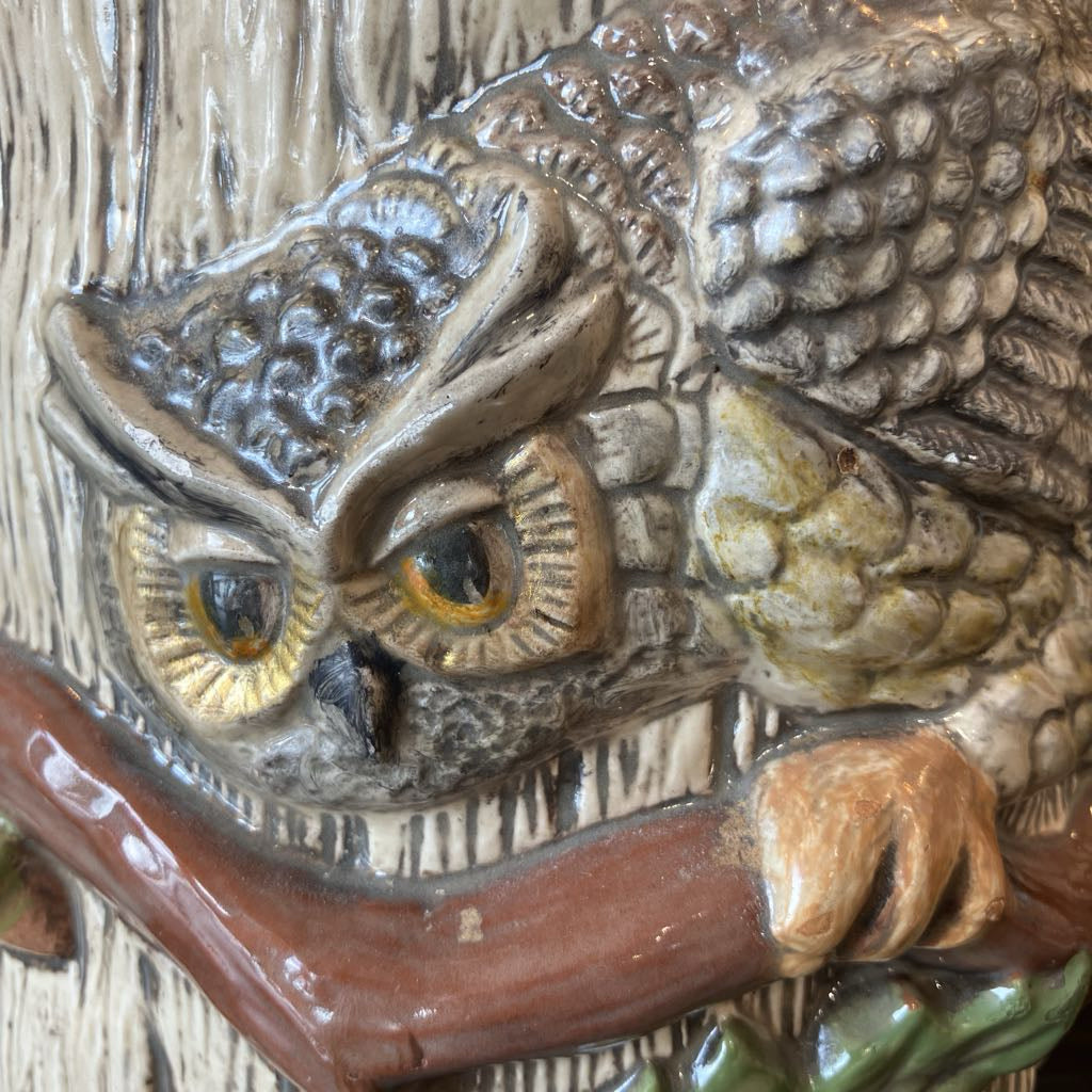 Close-up of a detailed owl figurine with a textured surface.
