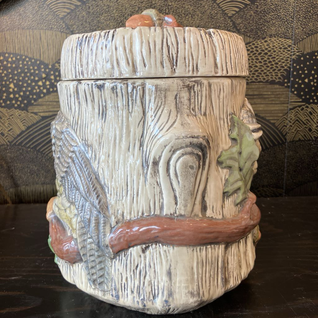 Decorative ceramic jar with animal figures on a patterned background
