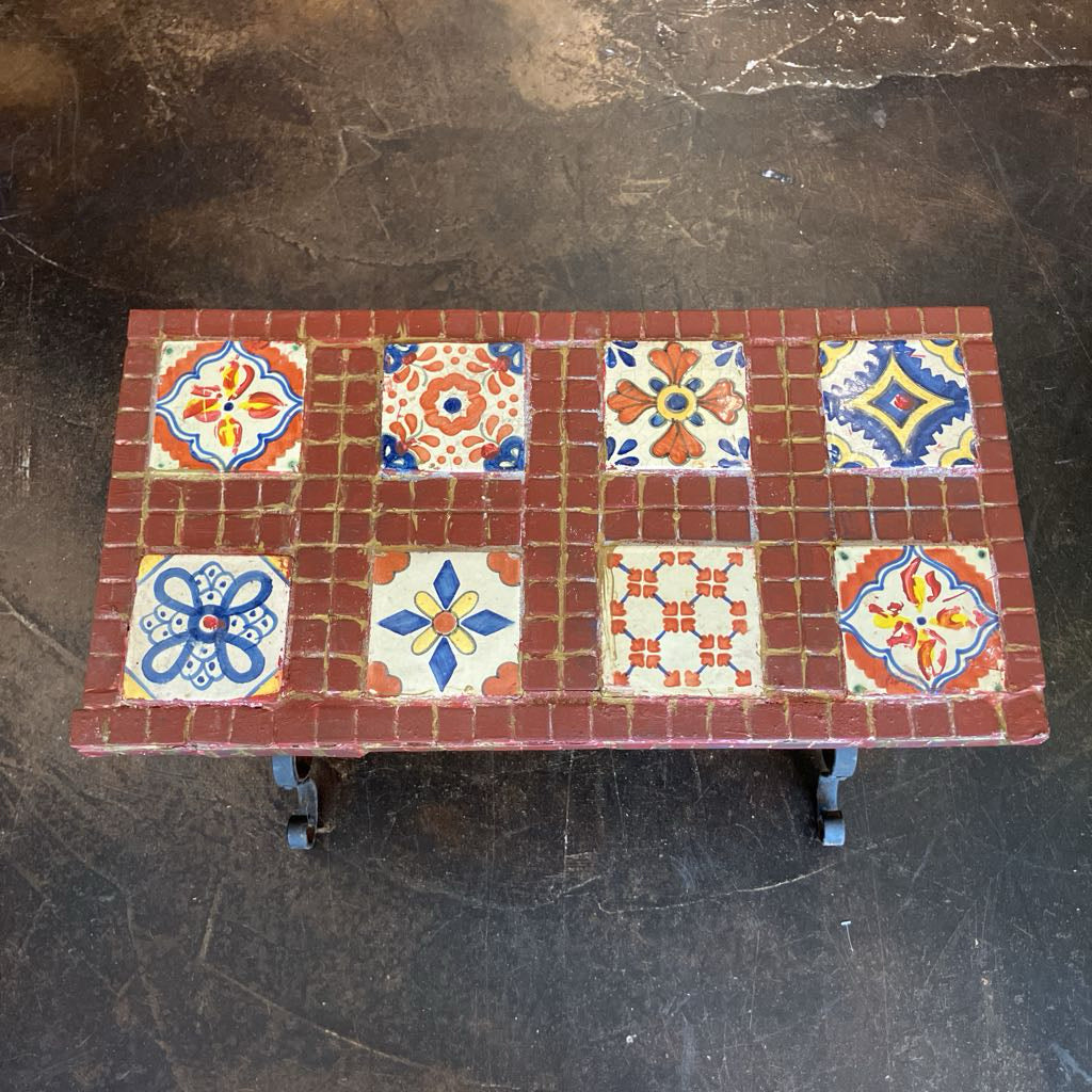 Small table with decorative tiles on a dark surface