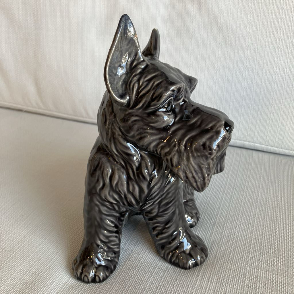 Ceramic dog figurine on a light-colored surface