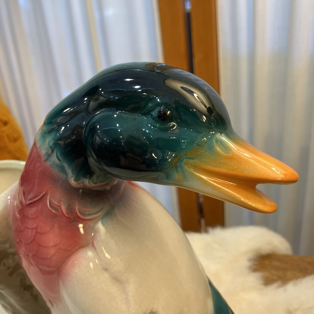Colorful ceramic duck figurine with a blurred background