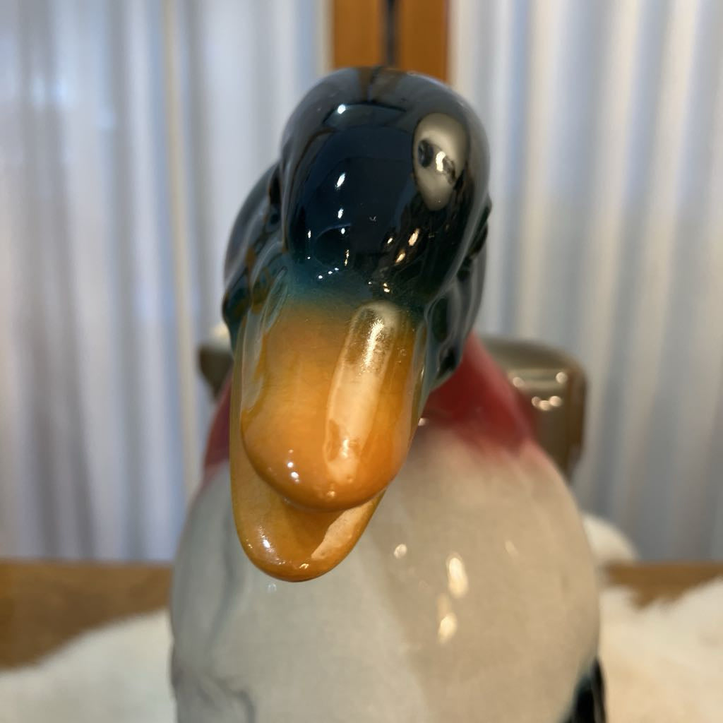 Close-up of a ceramic duck figurine with a blurred background