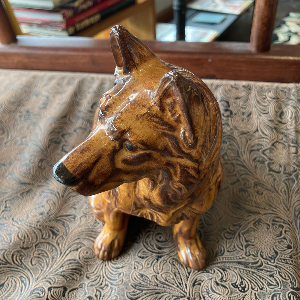 Brown ceramic dog figurine on a patterned surface