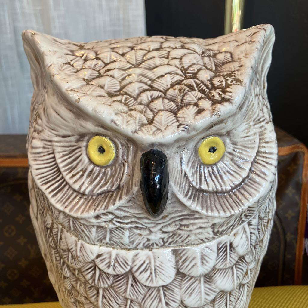 Decorative owl figurine with detailed feathers on a blurred background