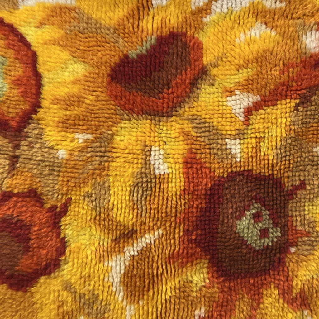 Close-up of a textured fabric with sunflower pattern