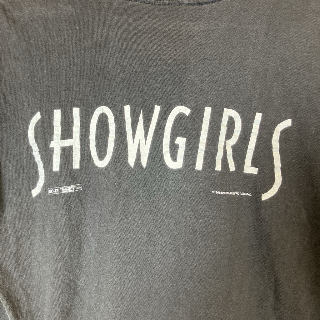 Gray t-shirt with 'SHOWGIRLS' text in white on a dark background