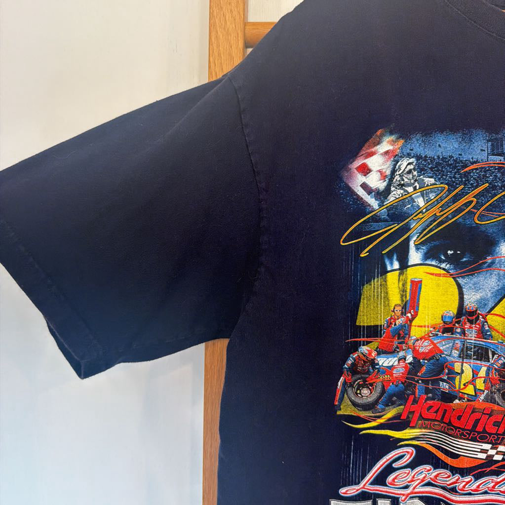 Black t-shirt with racing-themed graphic and text on a white background