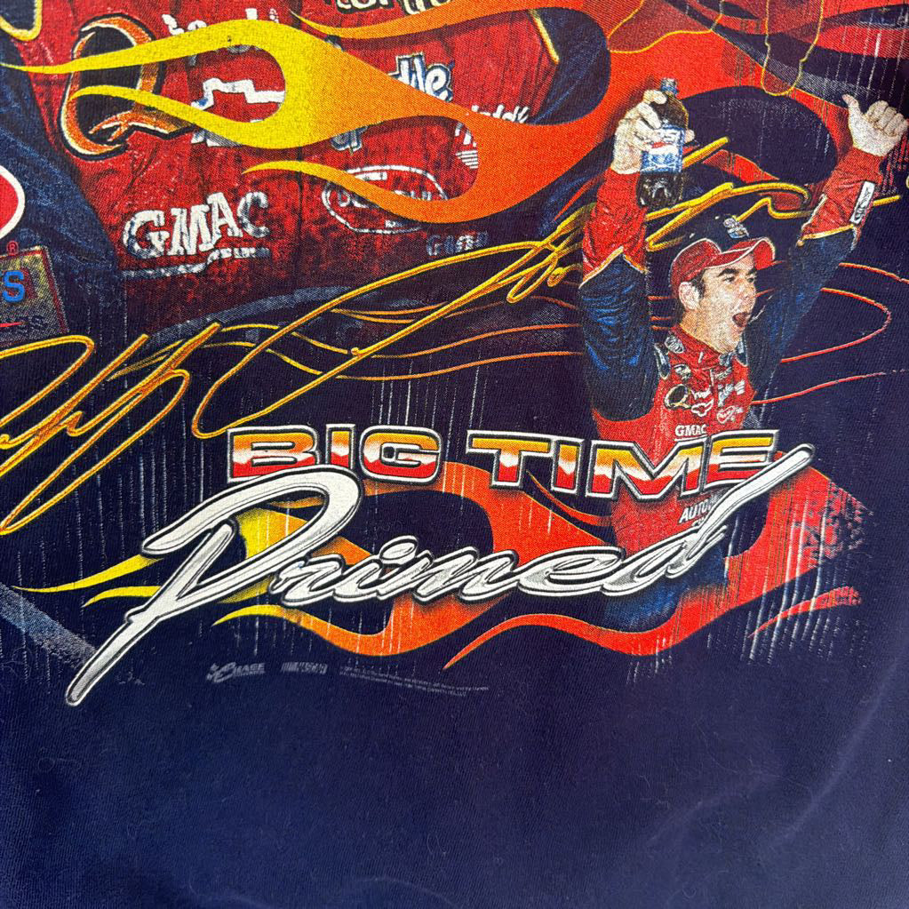 Promotional graphic with a driver celebrating, flames, and text on a dark background