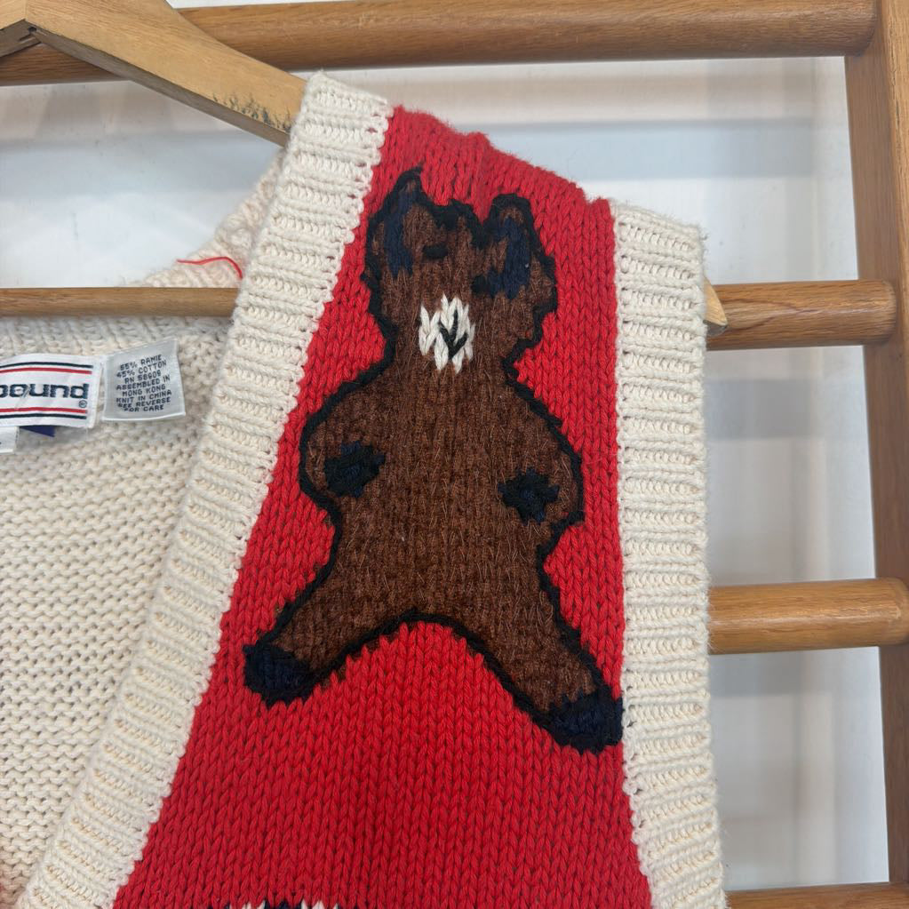 Knitted scarf with a bear design on a wooden hanger