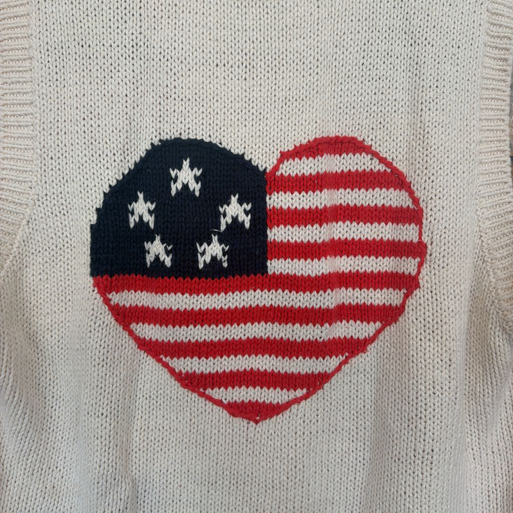 Heart-shaped design with American flag pattern on a textured fabric background