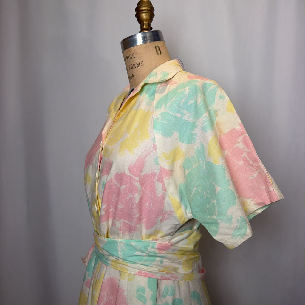 Pastel tie-dye dress on a mannequin against a gray background