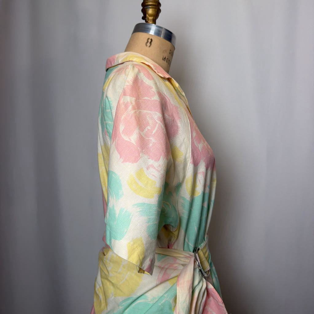 Pastel floral dress on a mannequin against a gray background