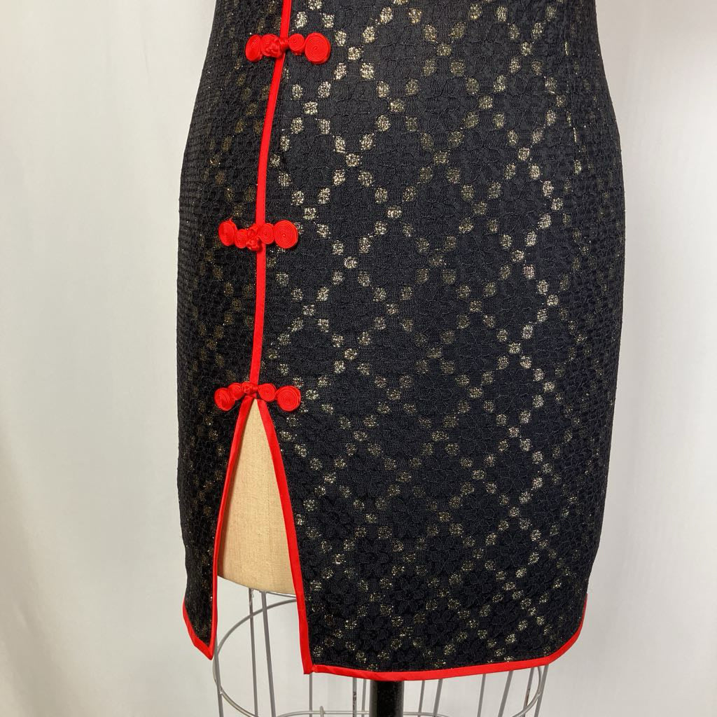 Black patterned skirt with red accents on a mannequin against a white background