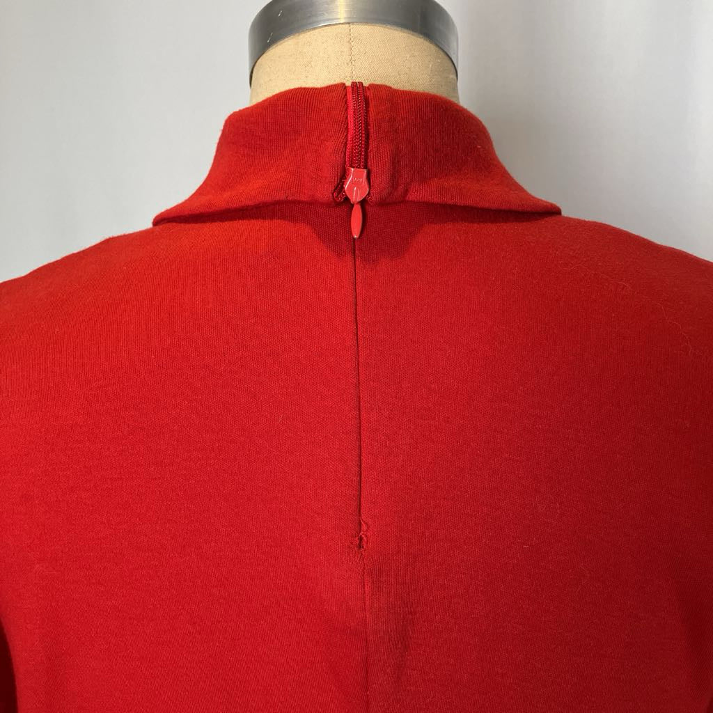 Red garment on a mannequin with a plain background