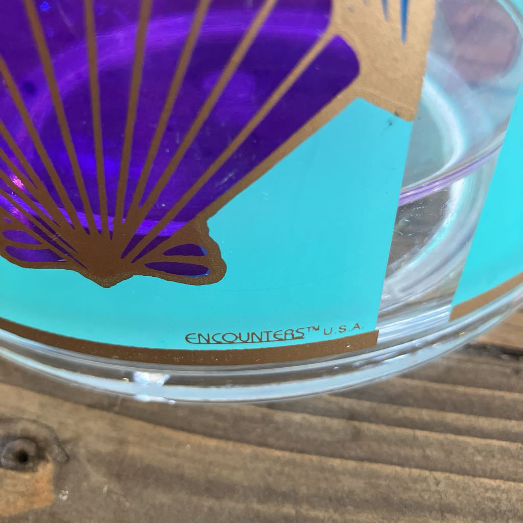 Clear plastic container with a butterfly design card on a wooden surface