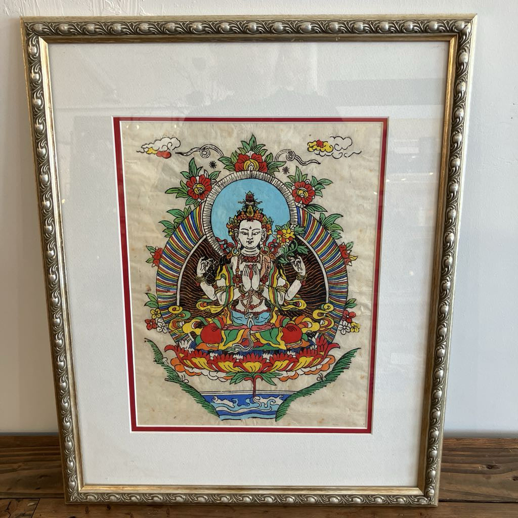 Framed artwork of a religious figure with colorful details on a white background