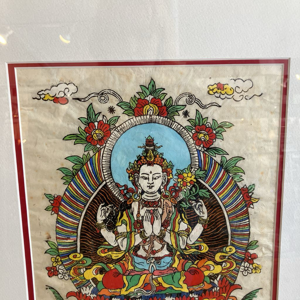 Colorful depiction of a seated figure with floral and decorative elements on a textured background