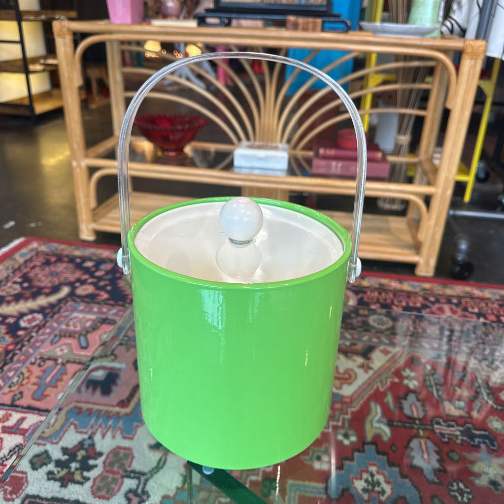 Green ice bucket with a clear glass shade on a patterned rug