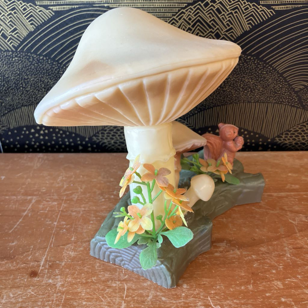 Mushroom-shaped object with floral decorations on a wooden surface